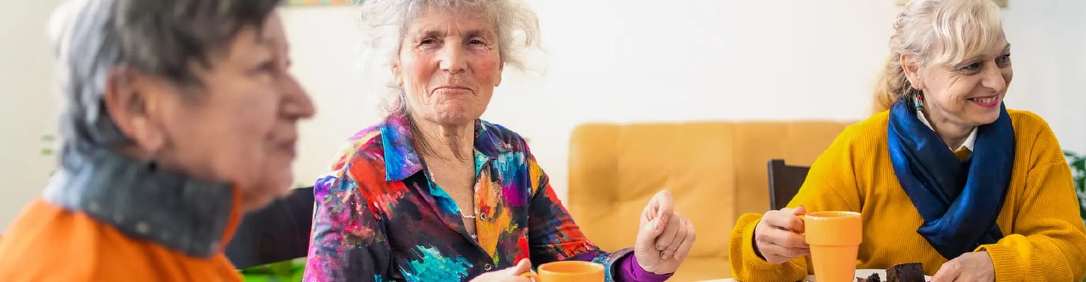 Residents enjoying coffee and conversation at a table