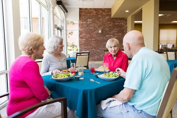 Residents enjoying a meal together in the dining room