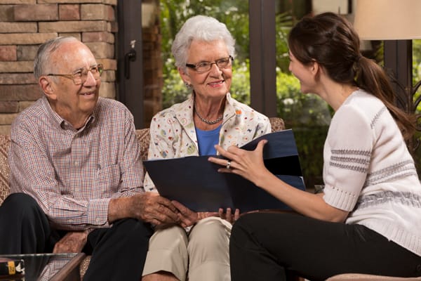Residents engaging with staff in a cozy lounge area