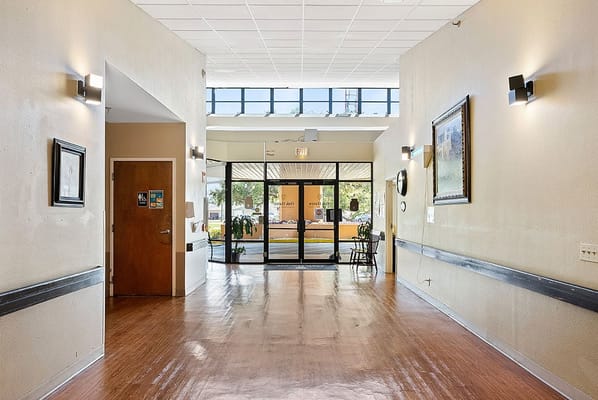 Bright interior hallway with exit to outside visible