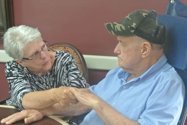 Two residents engaging in a conversation indoors
