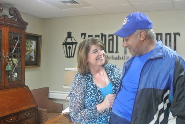 A resident and staff member interacting in a common area
