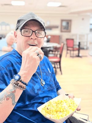 Resident enjoying popcorn in a common area