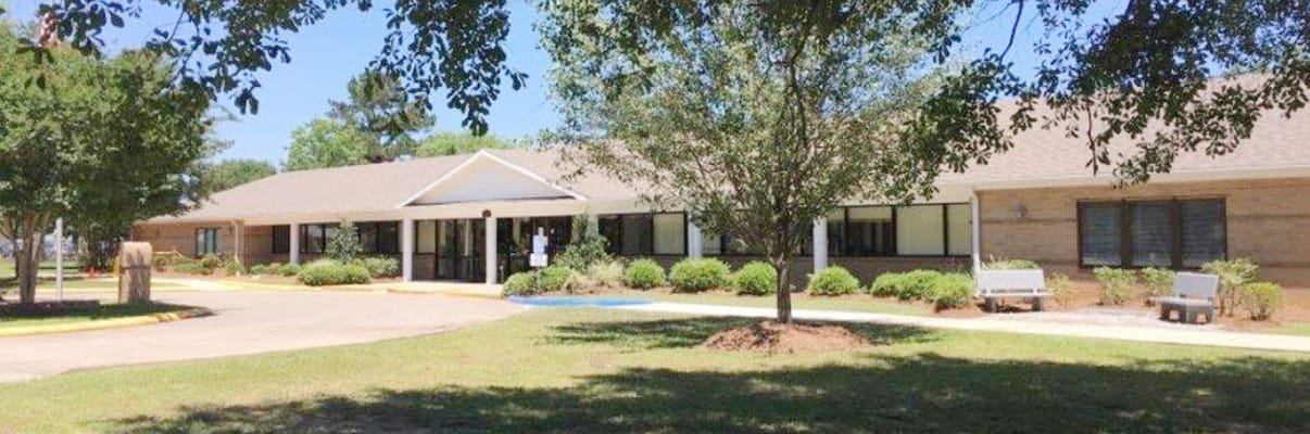 Exterior view of Good Samaritan Living Center surrounded by trees