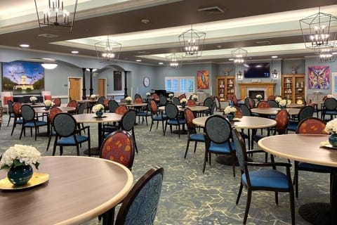 Bright dining room with tables and flowers