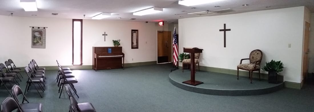 Interior view of a chapel with seating and a podium.