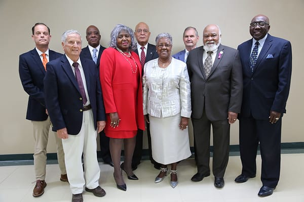 Group photo of residents and staff in a lobby