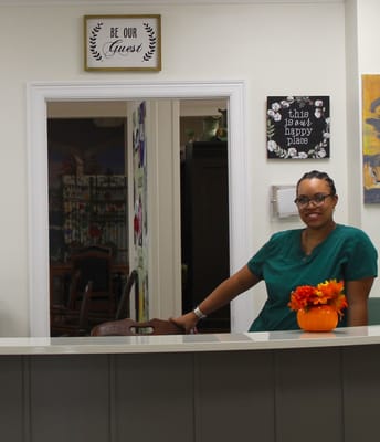Staff member in a warm interior space with decorations