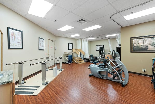 Interior view of a therapy room with exercise equipment