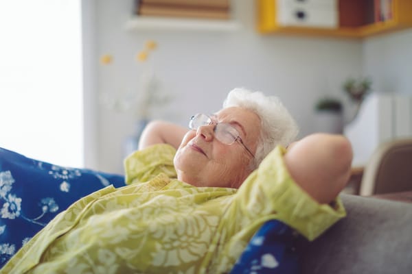 Senior woman relaxing comfortably in a cozy living space