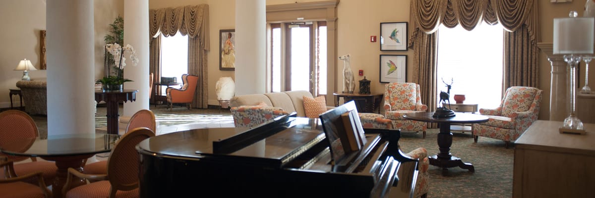 Bright interior common area with seating and piano