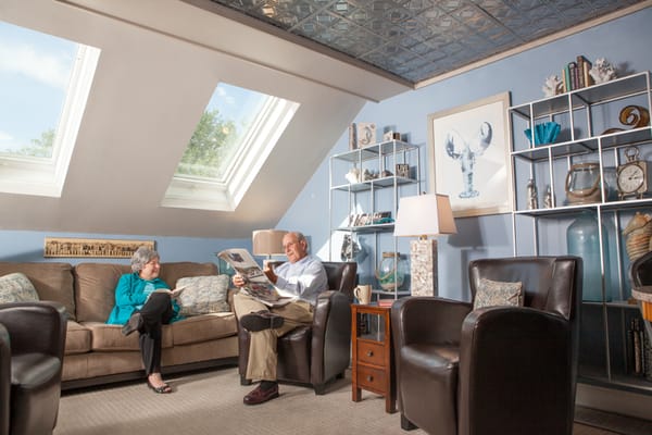 Residents relaxing in a common area with natural light