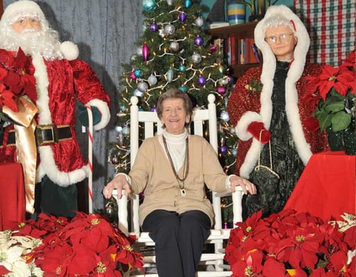 Resident posing with holiday decorations in common area