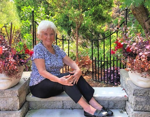 Resident enjoying a peaceful moment in the garden