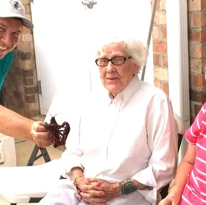 Residents enjoying an outdoor activity with a staff member