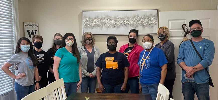 Staff members posing together in a common area