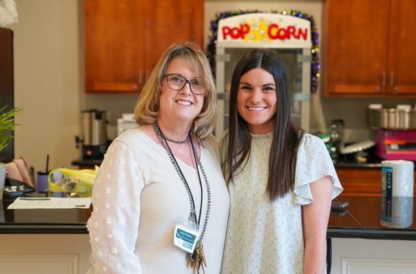 Staff members smiling in a bright common area