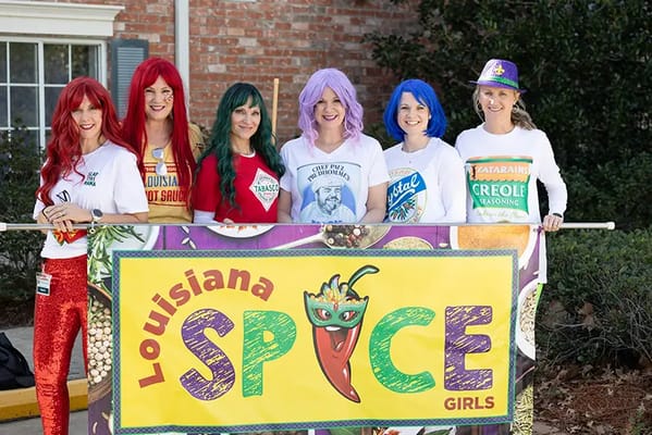 Staff members dressed in costumes celebrating Louisiana culture