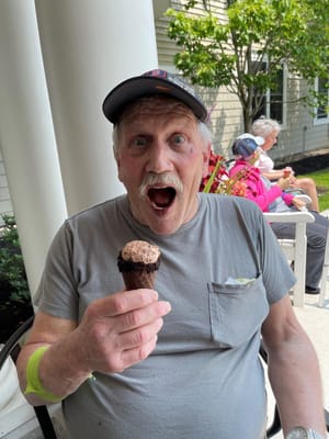 Resident enjoying an ice cream cone outside