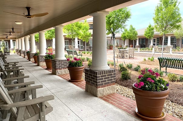 Outdoor patio area with benches and flowers
