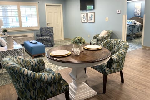 A cozy interior of a resident room with a dining table