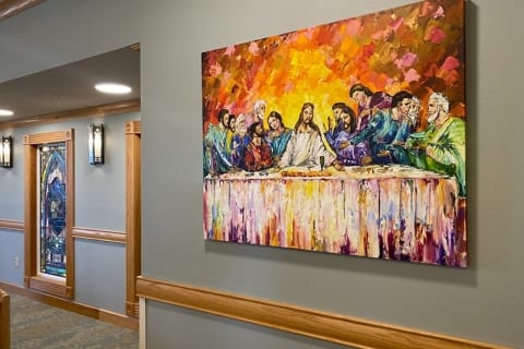 Colorful artwork depicting The Last Supper on a hallway wall