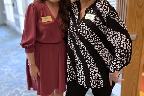 Two staff members posing together in the facility