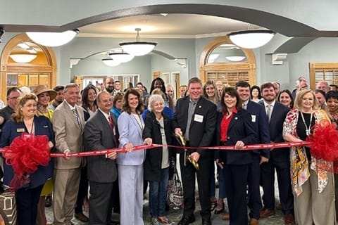 Ribbon-cutting ceremony with staff and community members