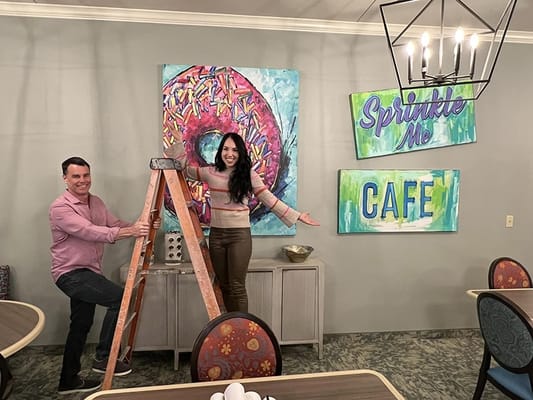 Staff decorating a colorful common area