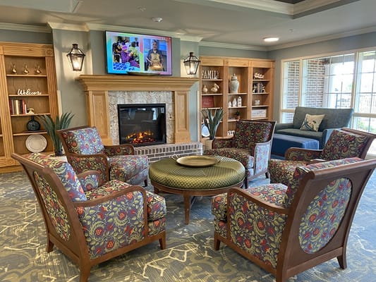 Cozy lounge area with a fireplace and colorful seating