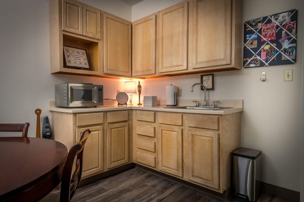 Well-lit kitchen area with cabinetry and appliances.