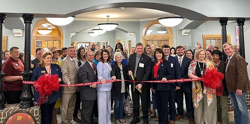 Ribbon cutting ceremony with residents, staff, and community members
