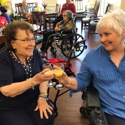 Residents celebrating with drinks in a common area