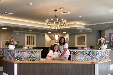 Staff members at the reception area in a brightly lit lobby