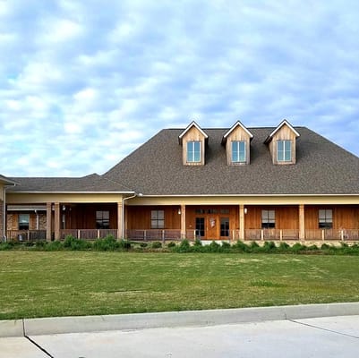 Exterior view of Lacour House facility with a landscaped front