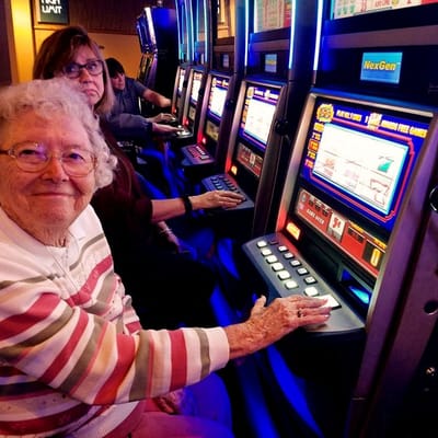 Residents enjoying slot machines in a lively activity area