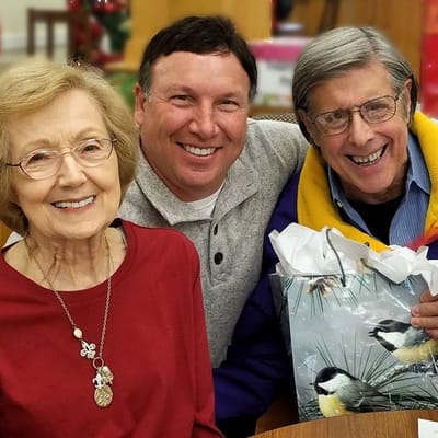 A resident with staff member enjoying holiday festivities