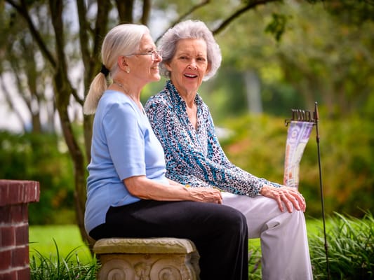 Two residents enjoying a conversation in the garden