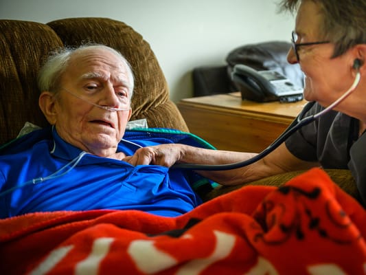 A caregiver monitoring a senior resident's health