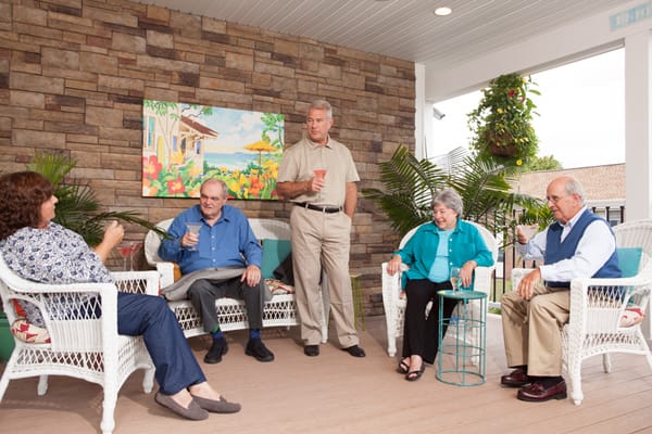 Residents enjoying drinks together in a cozy outdoor area