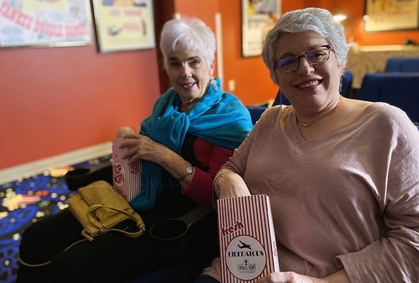 Residents enjoying a movie with popcorn