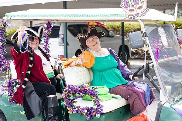 Residents dressed in costumes during a festive golf cart parade