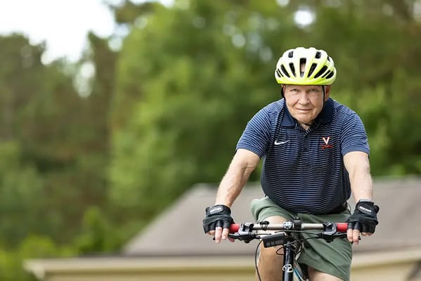 Man riding a bicycle outdoors in a helmet