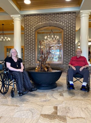 Residents sitting by an indoor fountain in a common area