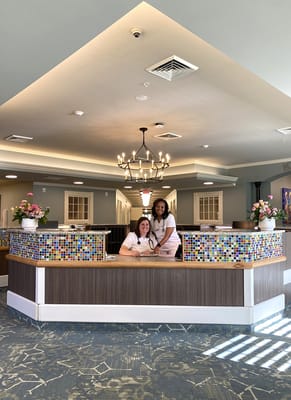 Reception area with staff members and colorful decor