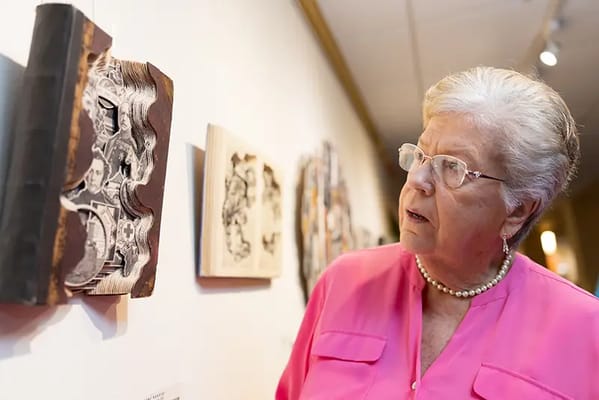 Resident admiring artwork in an interior space