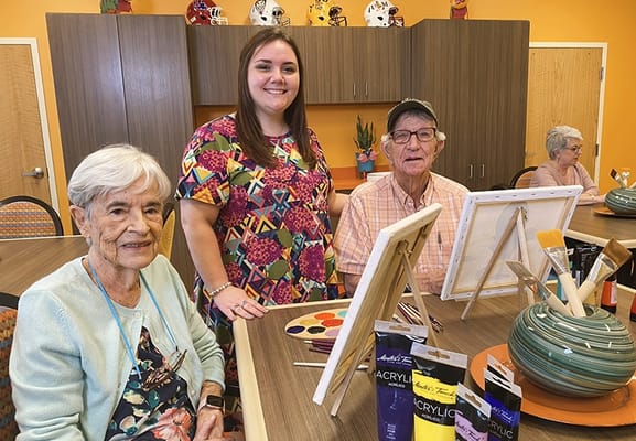 Residents participating in an art class with staff