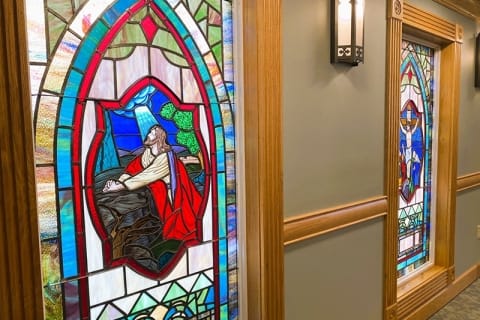 Stained glass windows in a facility hallway