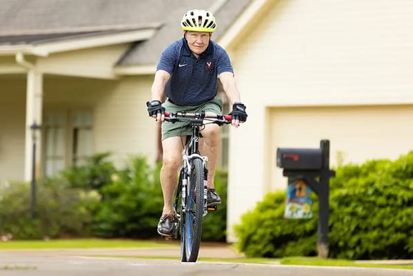 Senior man cycling in a suburban area