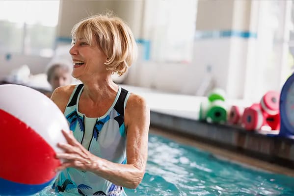 Senior woman enjoying water activities in a pool